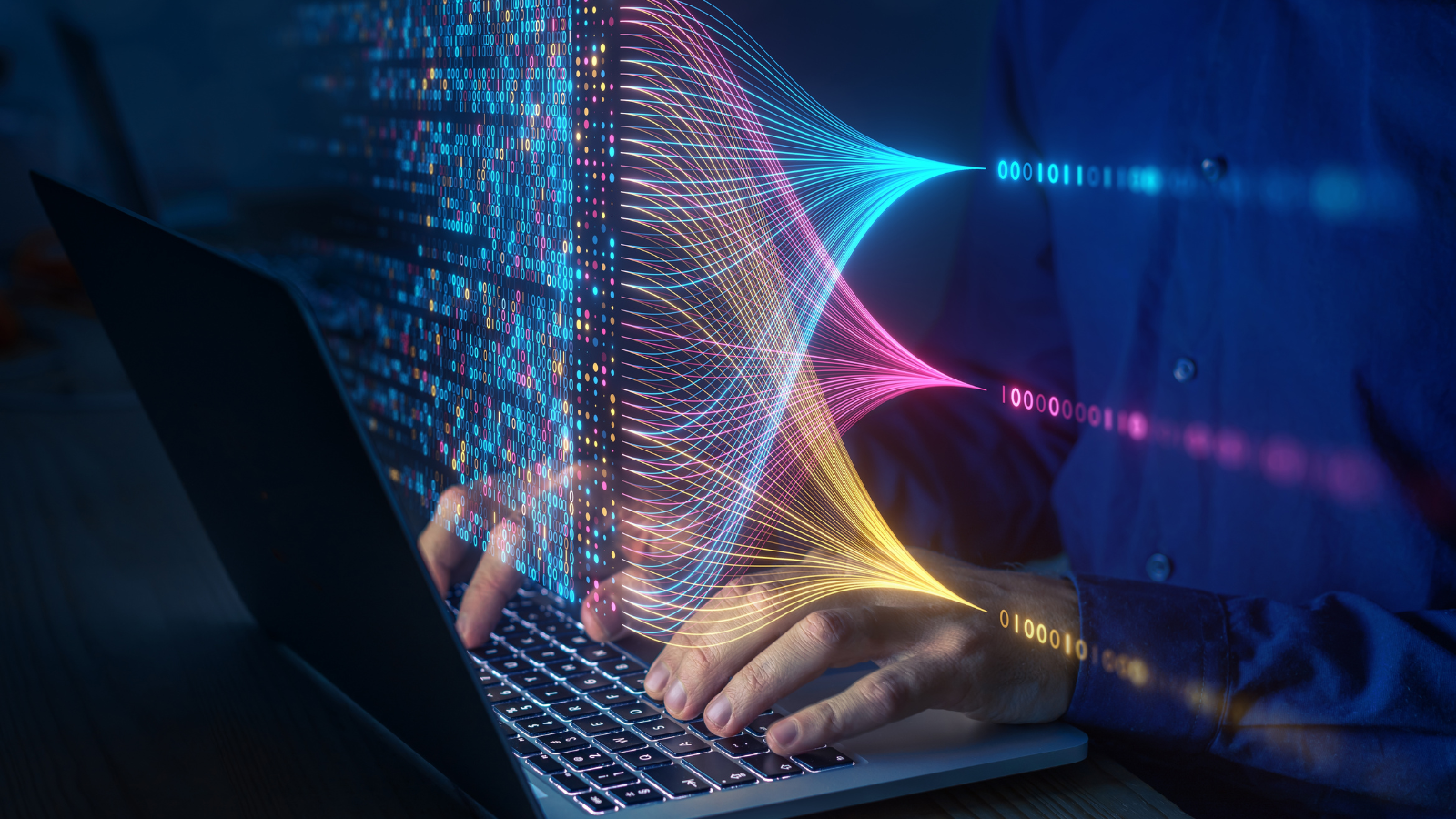 A person typing on a laptop with vibrant, colorful lines and binary code emanating from the screen, symbolizing data flow and connectivity. The setting appears to be a dimly lit room, focusing on technology and digital information exchange enhanced by the power of e-commerce. - CSA Catapult