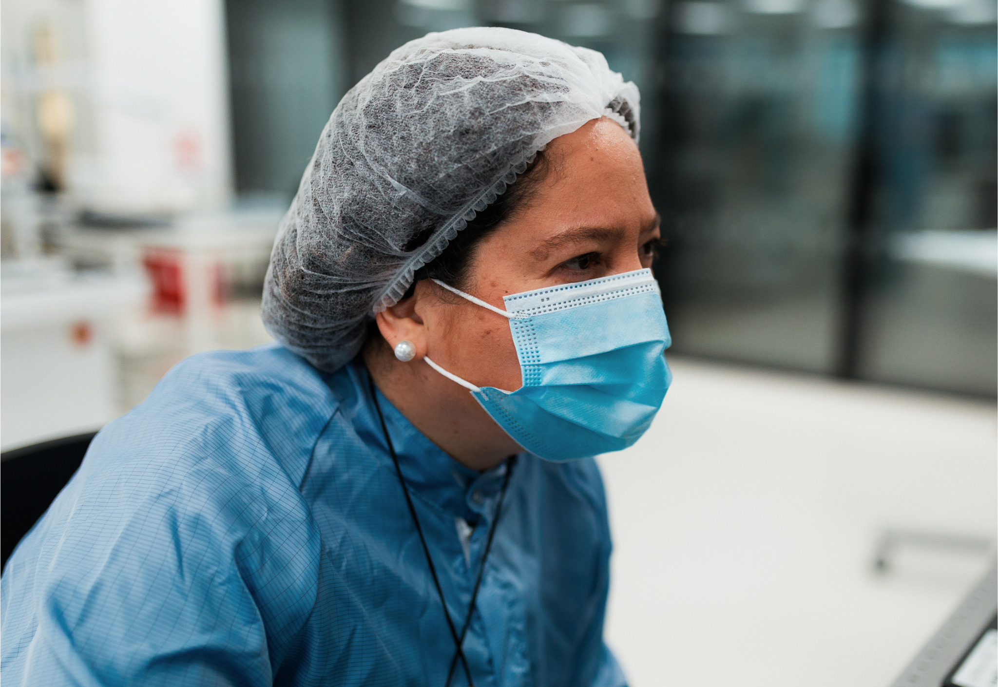 Pascaline Boulanger, in a lab coat, hair net, and face mask, works diligently in a laboratory environment. - CSA Catapult