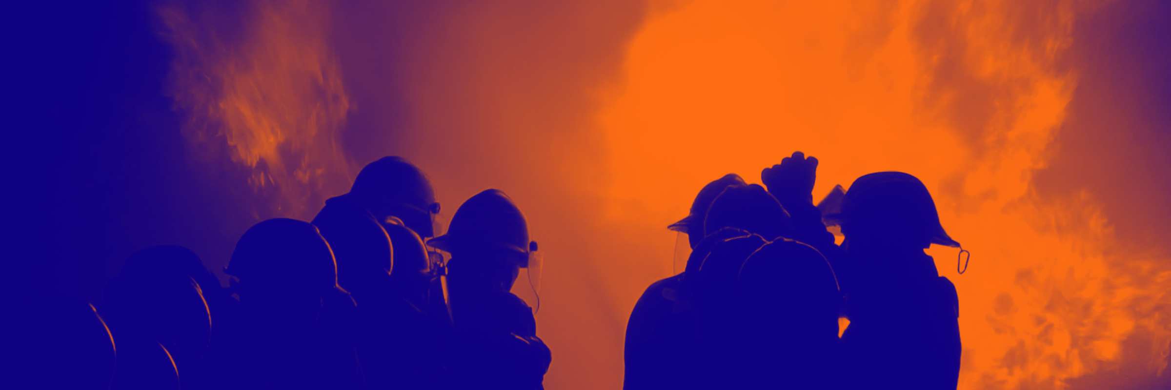 Silhouetted firefighters stand together, personal electronic devices glowing amid large flames and smoke. - CSA Catapult