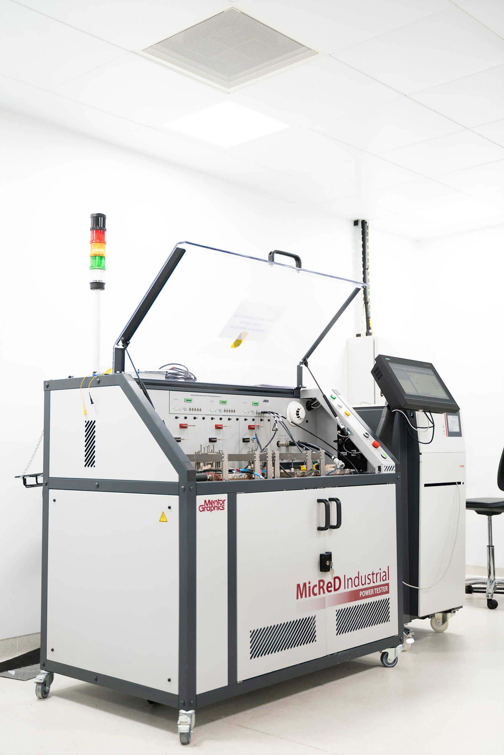 A MicReD Industrial machine for GaN testing with an open lid and control monitor in a bright, clean lab setting. - CSA Catapult