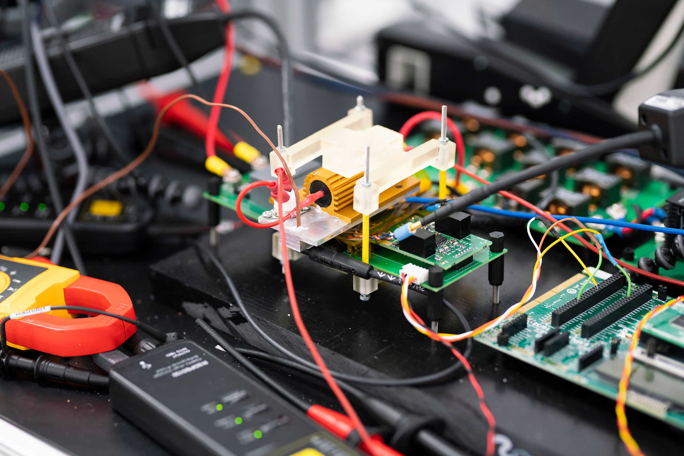 Close-up of GaN electronic circuit boards and wires connected for testing or prototyping in a lab setting. - CSA Catapult
