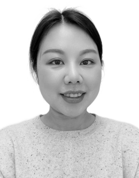 Smiling woman with dark hair in a light sweater, photographed against a plain white background, evokes an AI portrait. - CSA Catapult